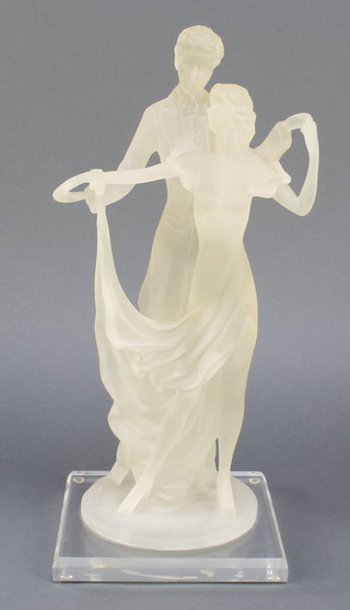 A perspex figure group of 2 standing dancers, raised on a square base, 13 1/2" 