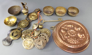 A leather Martingale hung 3 horse brasses, a collection of various horse brasses, a circular embossed copper jelly mould 7 1/2", 3 Indian embossed brass dishes decorated elephants 4" and 2 other dishes 
