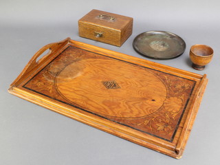 A circular bronze dish marked 3", an Art Nouveau oak inlaid twin handled tea tray 21" x 13" (damage by one of the handles), an oak box with hinged lid 3" x 7" x 5" and a turned wooden bowl 2 1/2" x 3" 