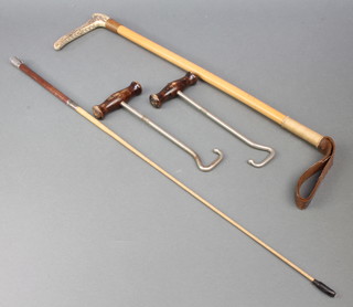 A leather riding crop with stag horn handle, a whip together with a pair of boot hooks 