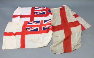 2 printed white ensigns 27" x  52" and 26" x 51" (moth holes), 2 stitched St Georges flags 15" x 34" and 24" x 52" (moth and holed) 