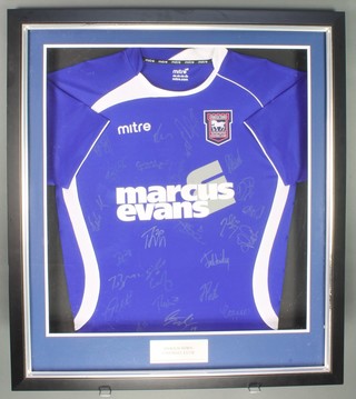 An Ipswich Town Football Club 2011 home football shirt, framed, with numerous players signatures, purchased at a Lord's Taverners Bobby Robson memorial charity lunch 13 May 2011, together with a ticket for the event 


 