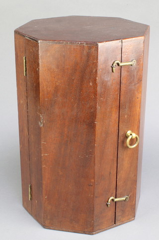 A 19th Century octagonal mahogany "display" box enclosed by panelled doors with brass handle, the velvet lined interior with remnants of a Garrard label 16"h x 10"w x 10"d 