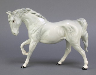 A Beswick figure of a grey and dappled horse with raised front right leg 11" 
