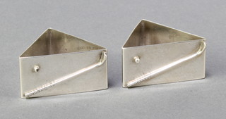 A pair of Art Deco silver triangular shaped napkin rings with golf club and ball motif, Birmingham 1927, 44 grams 