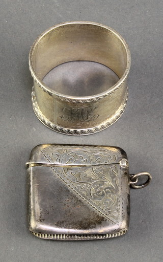 An Edwardian silver vesta with chased scroll decoration and inscription, Birmingham 1902 together with an Edwardian silver napkin ring Chester 1908, 58 grams