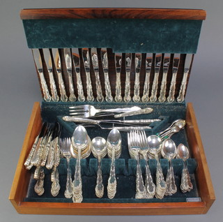 A silver plated canteen of cutlery with fancy handles contained in a fitted case 
