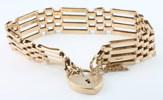 A 9ct yellow gold gate bracelet with heart padlock, 16 grams