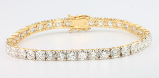 A good  18ct yellow gold 39 stone brilliant cut diamond set line bracelet, 9.9ct, 172mm 