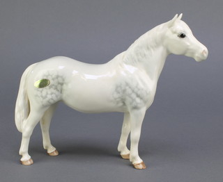 A Beswick figure of a white dappled horse - Connemara 9" 