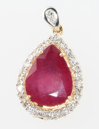A yellow gold pear shaped ruby (treated) and diamond pendant, the pear shaped stone surrounded by 26 brilliant cut diamonds 