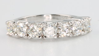 An 18ct white gold 7 stone diamond ring, the brilliant cut stones approx. 1.73ct, size N 1/2
