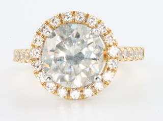 An 18ct yellow gold brilliant cut diamond ring, the centre stone approx. 3.72ct surrounded by brilliant cut diamonds to the mount and shank approx. 0.57ct size M 