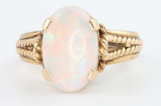 A yellow gold oval opal set dress ring, size Q
