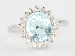 An 18ct white gold oval aquamarine and diamond ring, the centre stone approx. 2.44ct surrounded by brilliant cut diamonds approx 0.37ct, size N 1/2