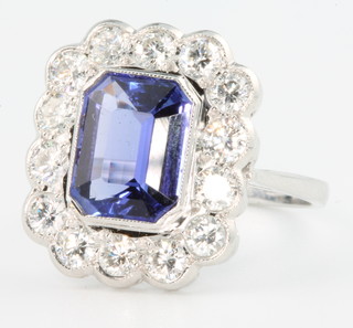 An 18ct white gold tanzanite and diamond Art Deco style ring, the centre stone approx. 3ct surrounded by 14 brilliant cut diamonds 1.03ct size N 
