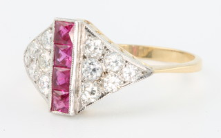 An 18ct yellow gold Art Deco style ruby and diamond cocktail ring with 4 princess cut rubies and 12 brilliant cut diamonds, size M 1/2