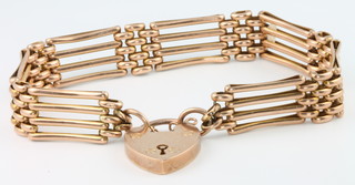 A 9ct yellow gold gate bracelet with heart padlock, 14 grams