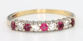 An 18ct yellow gold ruby and diamond half hoop ring size P 