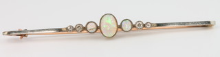 A yellow gold 3 stone opal and 4 stone diamond bar brooch 