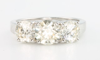 An 18ct white gold 3 stone diamond ring, the centre stone 1.06ct the 2 outer stones 1.49ct, size M 1/2
