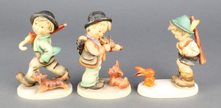 3 Hummel figures - boy with red rabbit 6/0 5 1/4", violin player with puppy 5 1/4" and boy with umbrella and dog 5.  5 1/4" 