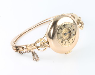 An 18ct yellow gold ladys half hunter fob watch contained in a yellow gold case and bracelet 18 grams 