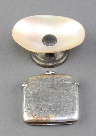 A Victorian silver vesta with chased scroll decoration Chester 1900 34 grams together with a shell salt with silver base  