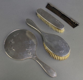 A silver engine turned brush set with floral decoration comprising hand mirror, clothes brush, hair brush and comb