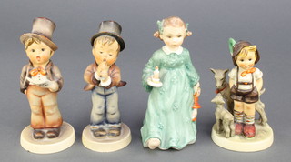 4 Hummel figures - girl with chamber stick 17 5 1/4", boy with song sheet 737 5 1/4", boy with flute 85/0 5" and little goat herder 5 1/4" 