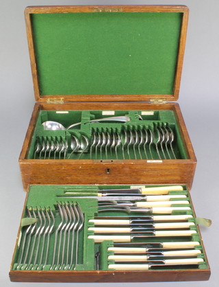 An Edwardian oak canteen containing a set of silver plated cutlery for 6 