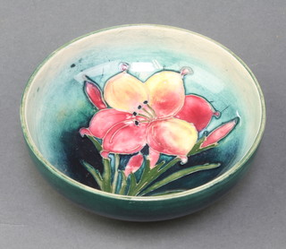 A Moorcroft shallow blue dish with fresia, printed and impressed marks 4 1/2" 