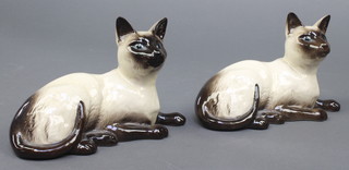 A pair of Royal Doulton figures of reclining Siamese cats 1559 7" 