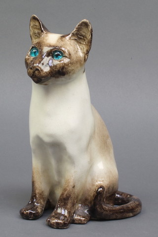 A Studio Pottery figure of a Siamese cat with glass eyes, indistinctly signed 9" 