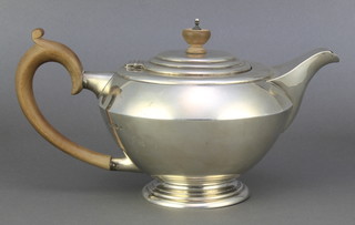 An Art Deco silver teapot with fruit wood mounts, London 1937, gross 564 grams