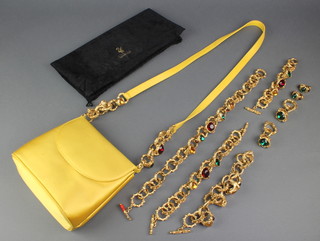 An impressive suite of Swarovski gilt and gem set jewellery comprising 3 bracelets, 1 necklace and 2 pairs of earrings together with a yellow satin evening bag similarly decorated 