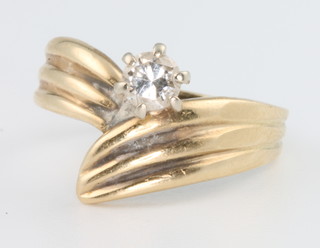 A lady's stylish yellow gold single stone diamond whorl ring size P 