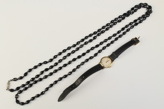 A lady's gilt cased Omega quartz wristwatch together with a jet style necklace