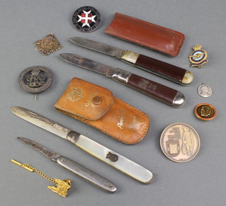 Minor badges and a silver and mother of pearl fruit knife etc