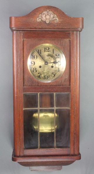 A 1930's chiming wall clock with silvered dial and Arabic numerals contained in an oak case 
