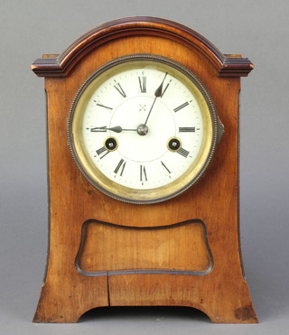 Hamburg American Clock Co., a striking mantel clock with enamelled dial and Roman numerals contained in an arch shaped walnut case 