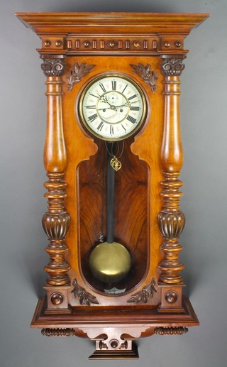 A 19th Century Vienna style striking regulator with 7 1/2" enamelled dial with Roman numerals, contained in a carved walnut case 
