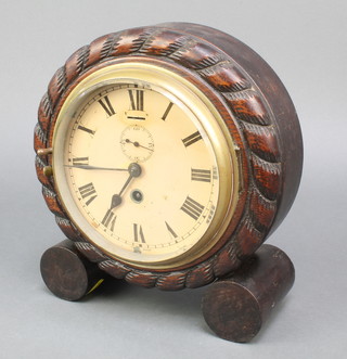 A Swiss timepiece with 5 1/2" painted dial, Roman numerals and subsidiary second hand contained in a carved rope decorated case 