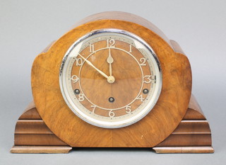 A 1950's 8 day chiming mantel clock with pierced silvered chapter ring and Roman numerals, contained in a walnut case 

