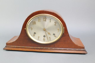 A chiming mantel clock with oval silvered dial and gilt Arabic numerals, contained in a mahogany admirals hat shaped case 
