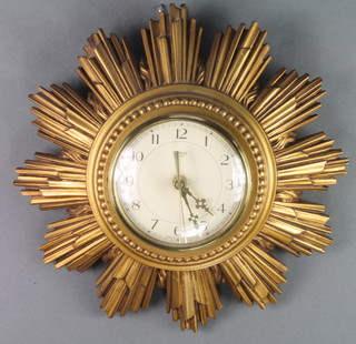A Smiths battery operated wall clock with paper dial and Arabic numerals contained in a gilt painted resin sunburst case 13" 