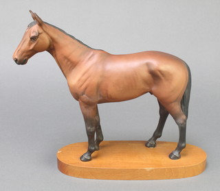 A Beswick figure of a horse - Mill Reef 7" on a wooden socle together with The Story of Mill Reef by John Oaksey
