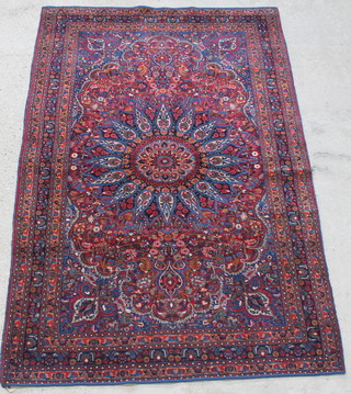 A red and blue ground Persian Dorokhsh rug 62 1/2" x 53", some wear and edges bound 