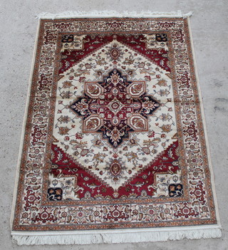 A gold and red ground Belgian cotton Heriz rug with diamond shaped medallion to the centre 76" x 53" 