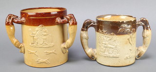 A Doulton Lambeth 3 handled loving cup/tyg decorated hunting and tavern scenes, the handles in the form of greyhounds, impressed Doulton Lambeth England 6" together with a 19th Century salt glazed twin handled loving cup decorated a tavern scene and St George slaying the dragon with greyhound handles 5" 
